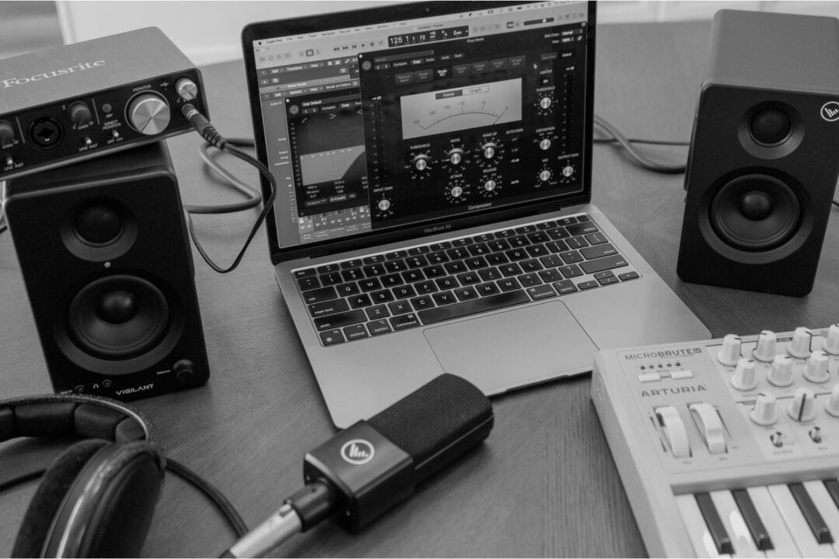 SwitchOne Speaker with a laptop as a project studio setup, incudes VA92 mic and arturia synth and macbook pro.